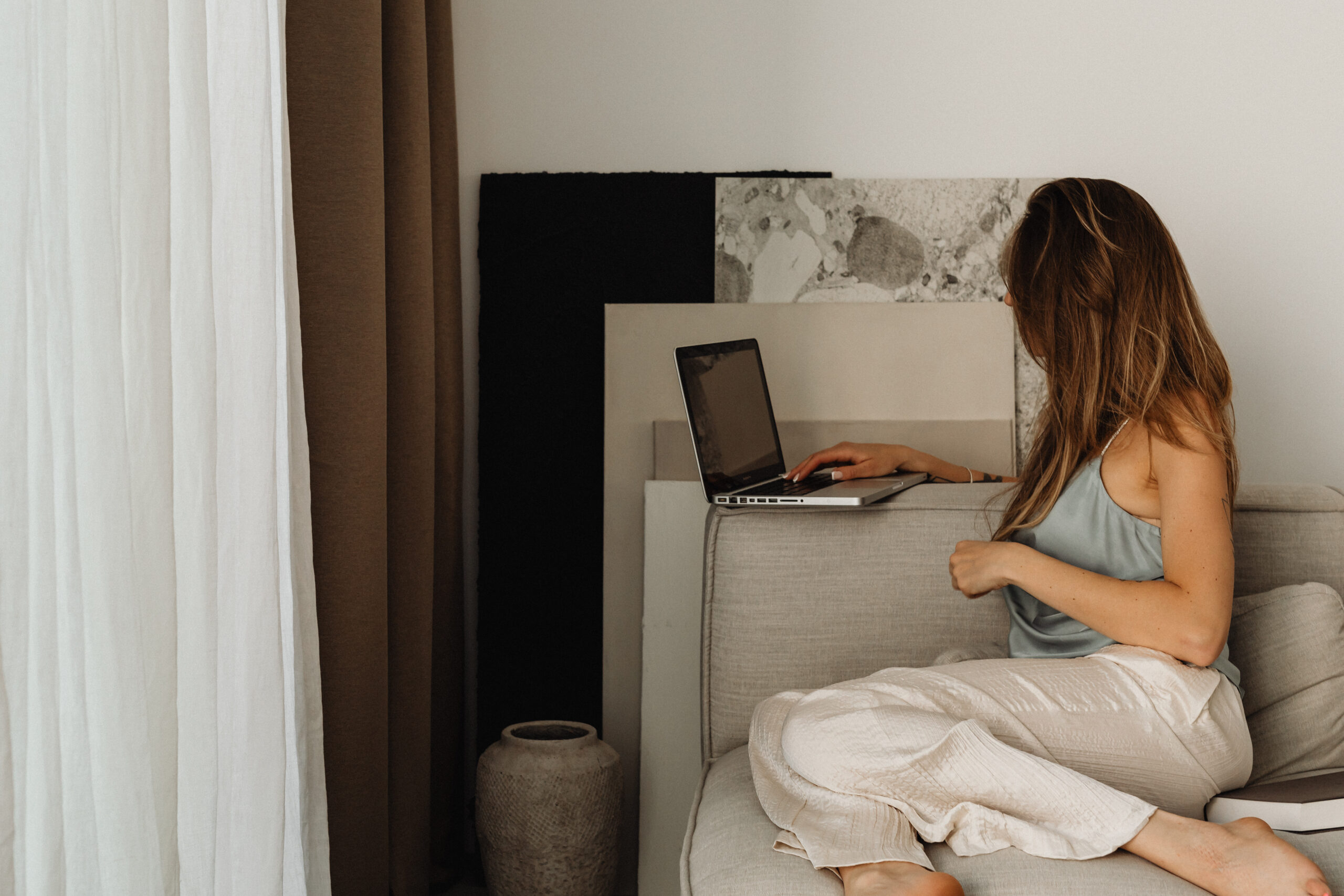 Female business owners working on a social media strategy at home on a laptop